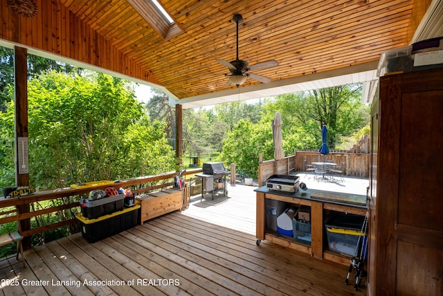 7761 W Herbison Rd, Dewitt, MI 48820 - wooden deck with outdoor dining space, area for grilling, and a ceiling fan
