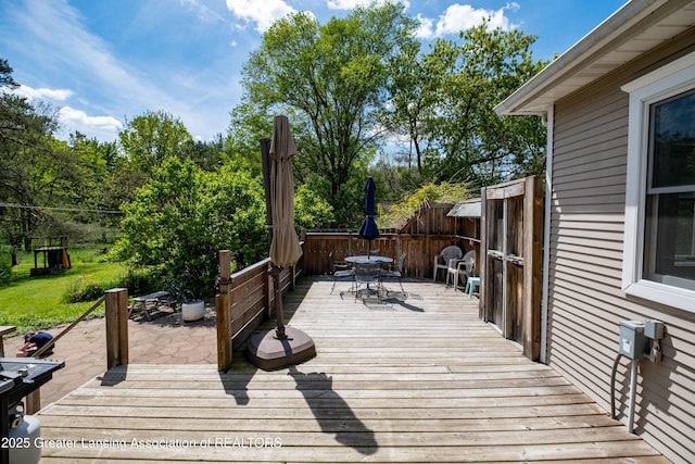 7761 W Herbison Rd, Dewitt, MI 48820 - wooden deck featuring outdoor dining area