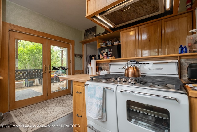 7761 W Herbison Rd, Dewitt, MI 48820 - kitchen with range with two ovens, open shelves, french doors, brown cabinetry, and wood finished floors