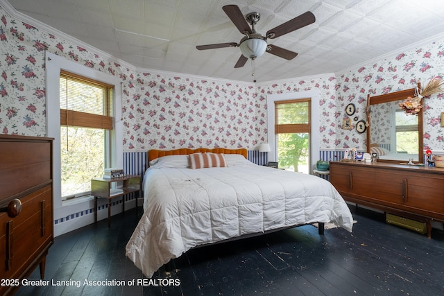 7761 W Herbison Rd, Dewitt, MI 48820 - bedroom featuring wood-type flooring, wallpapered walls, ornamental molding, multiple windows, and a ceiling fan