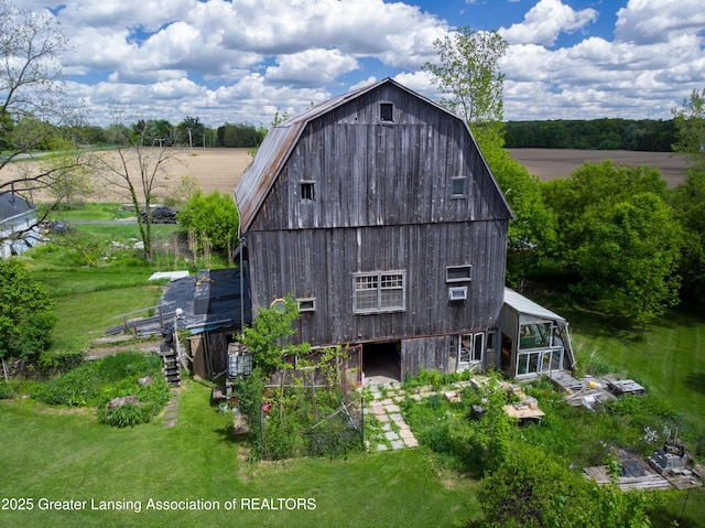 7761 W Herbison Rd, Dewitt, MI 48820 - back of property featuring a barn, a gambrel roof, and an outbuilding