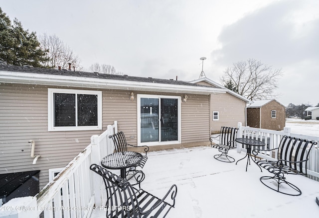 snow covered property featuring a deck