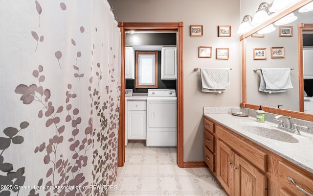 bathroom with washer / clothes dryer and vanity