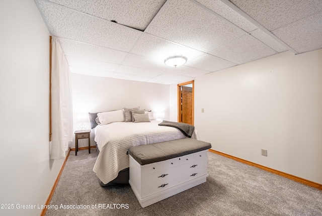 bedroom featuring a paneled ceiling and carpet