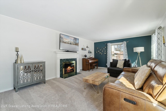 living room with a premium fireplace, carpet floors, and ornamental molding