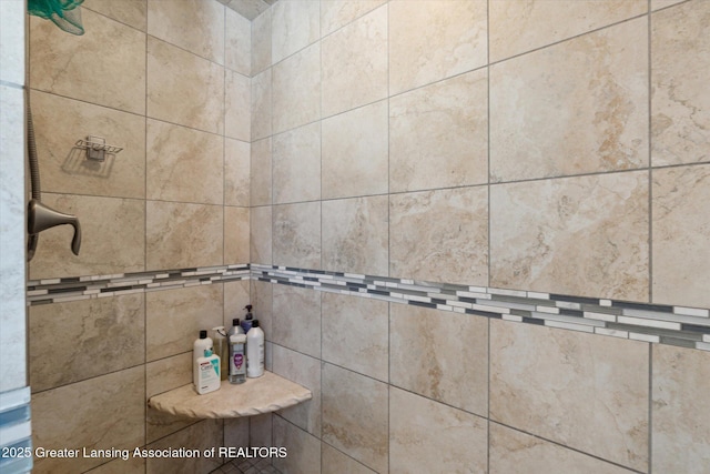 interior details with a tile shower