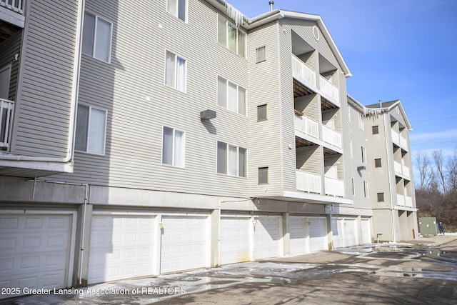 view of building exterior with community garages