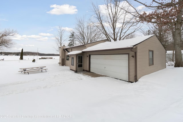 view of snow covered garage