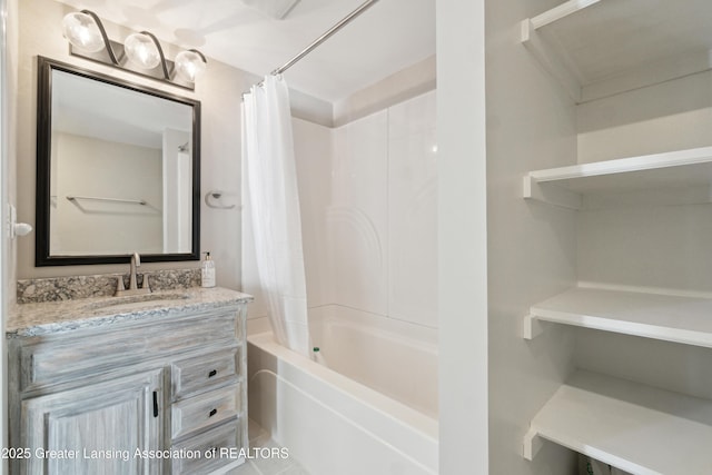 bathroom featuring shower / tub combo and vanity