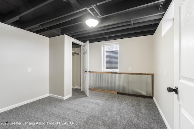 below grade area with carpet flooring, visible vents, and baseboards