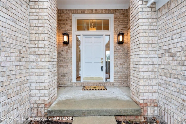 doorway to property with brick siding