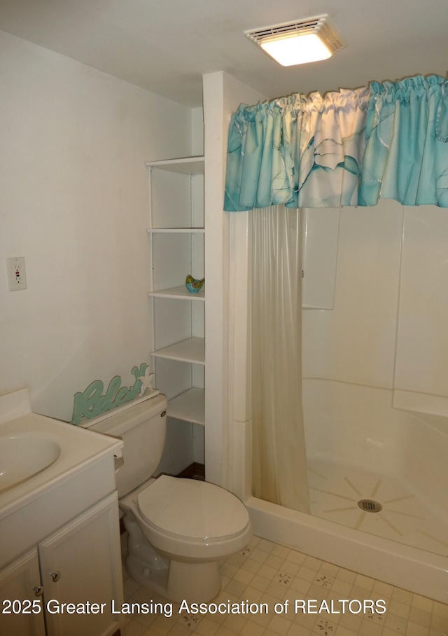 bathroom featuring visible vents, a shower stall, toilet, and vanity