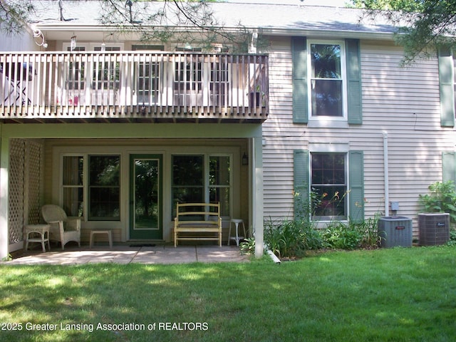 back of property with a lawn, a patio area, and cooling unit