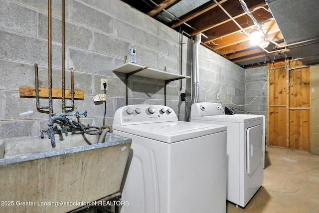 laundry room featuring laundry area, separate washer and dryer, and a sink