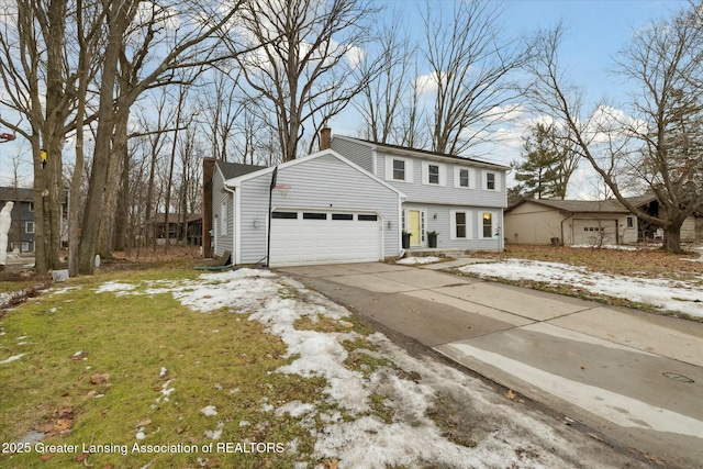 colonial home featuring a garage, concrete driveway, and a chimney