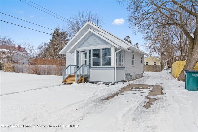 bungalow-style house with fence