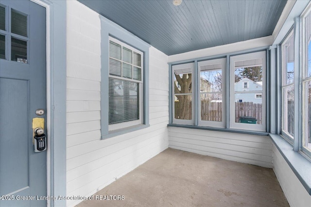 unfurnished sunroom with wooden ceiling