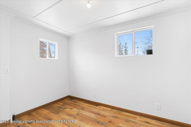 spare room with wood finished floors and baseboards