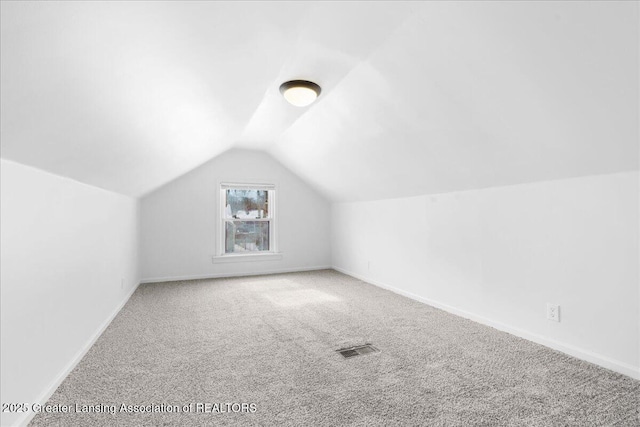 bonus room with lofted ceiling, carpet flooring, visible vents, and baseboards