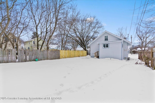 yard covered in snow with fence