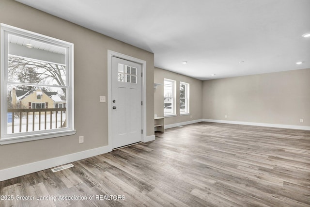 entryway with light wood-style flooring, recessed lighting, visible vents, and baseboards