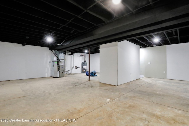 unfinished basement featuring heating unit and water heater