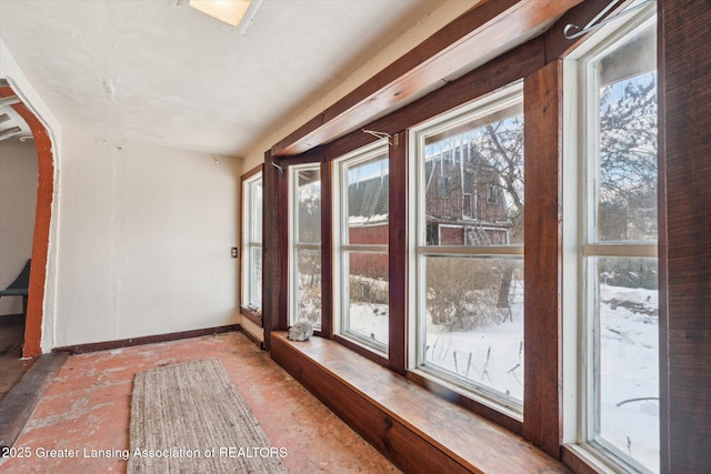 unfurnished sunroom with arched walkways