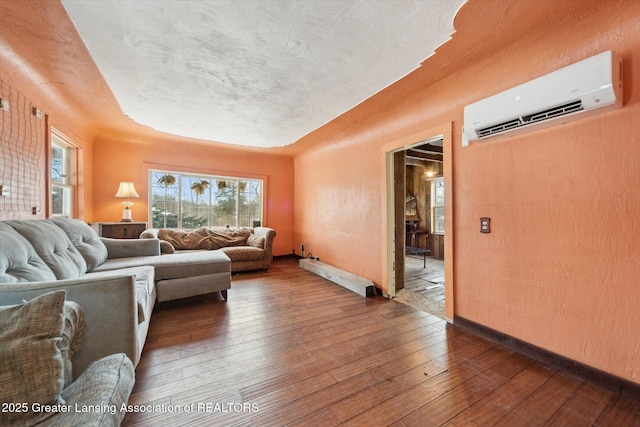 living room with plenty of natural light, dark wood-type flooring, a wall mounted air conditioner, and baseboards