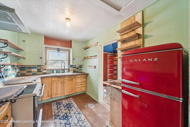 kitchen with white range with electric stovetop, open shelves, a sink, and exhaust hood