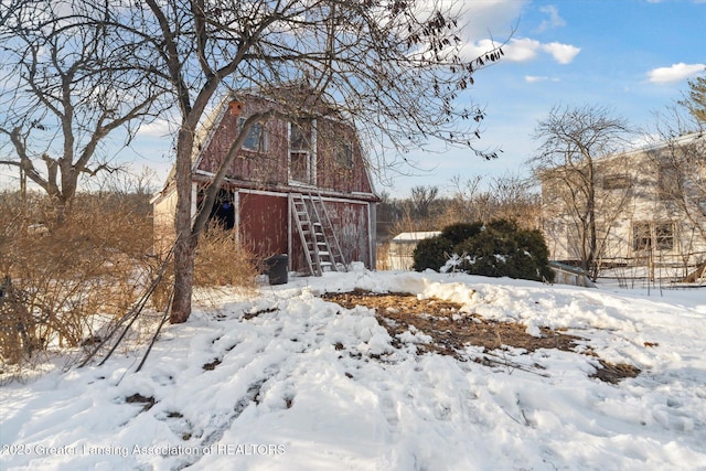 yard covered in snow with a barn