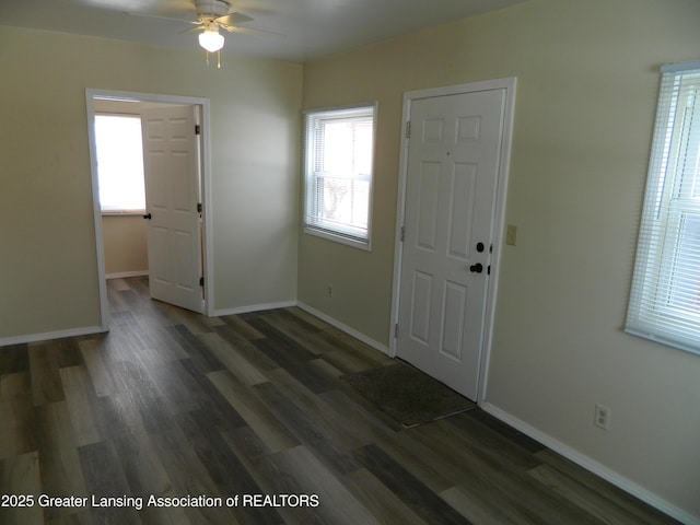 entrance foyer with a ceiling fan, wood finished floors, and baseboards