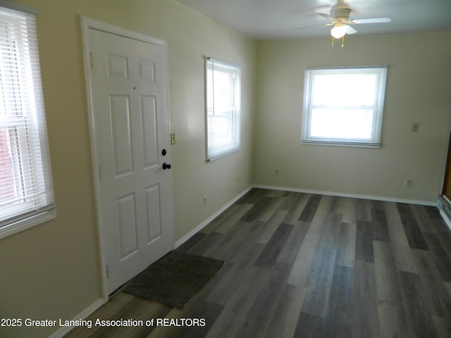 foyer entrance featuring a ceiling fan, wood finished floors, and baseboards