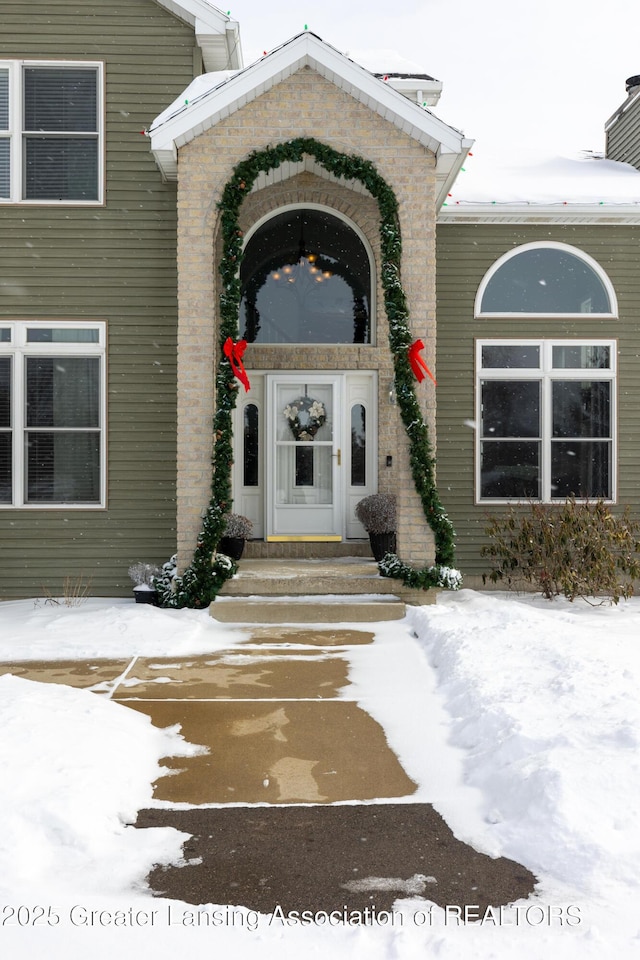 view of snow covered property entrance