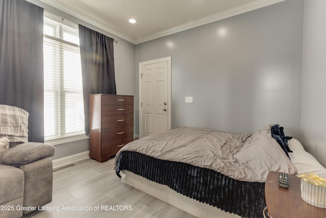 bedroom featuring baseboards, visible vents, crown molding, light wood-style floors, and recessed lighting