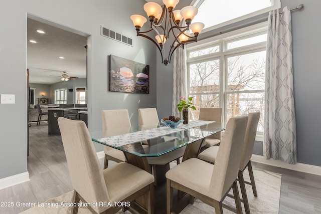 dining area with recessed lighting, ceiling fan with notable chandelier, visible vents, baseboards, and light wood-type flooring