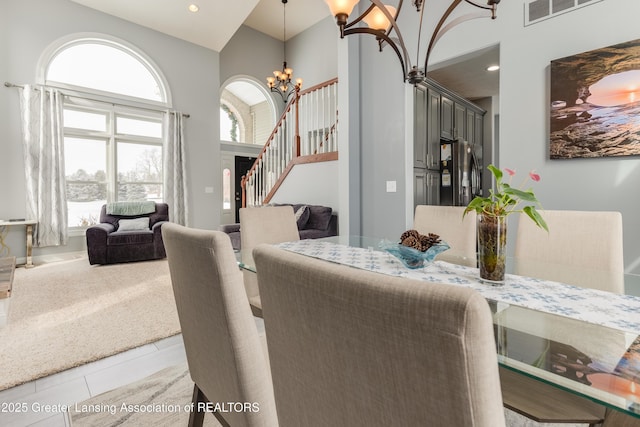 dining room with light tile patterned floors, recessed lighting, a notable chandelier, visible vents, and stairway