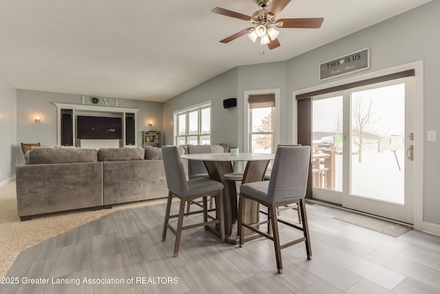 dining area featuring baseboards and a ceiling fan