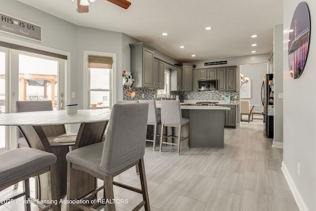 dining area featuring ceiling fan, baseboards, and recessed lighting