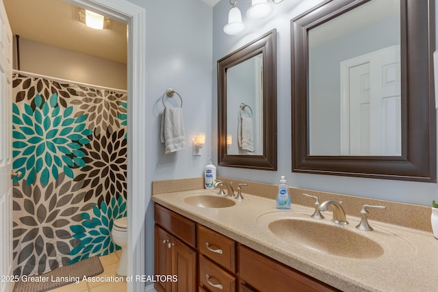 bathroom with tile patterned flooring, a sink, toilet, and double vanity