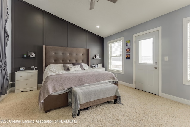 bedroom featuring light carpet, baseboards, a ceiling fan, and lofted ceiling