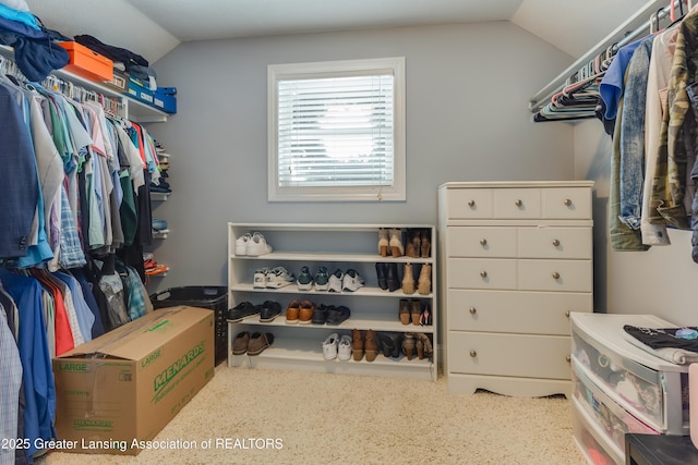 walk in closet featuring vaulted ceiling