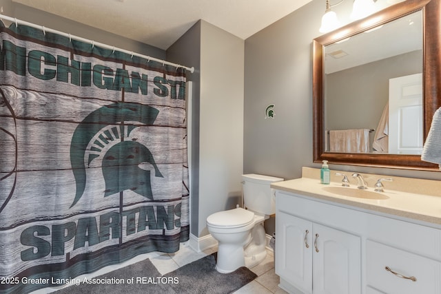 bathroom with toilet, curtained shower, vanity, and tile patterned floors