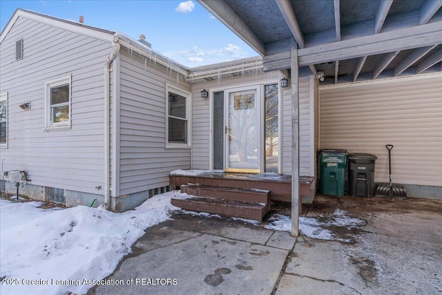 view of snow covered property entrance