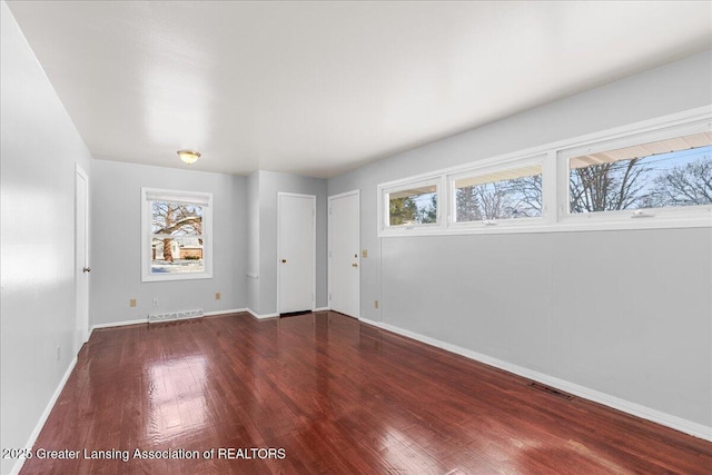 spare room with a wealth of natural light and visible vents