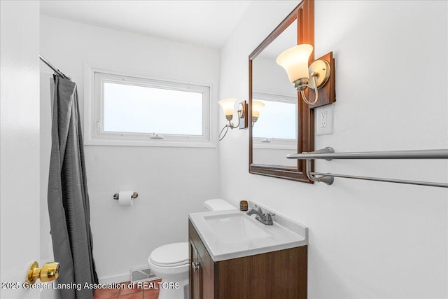 full bathroom with tile patterned flooring, vanity, toilet, and a healthy amount of sunlight