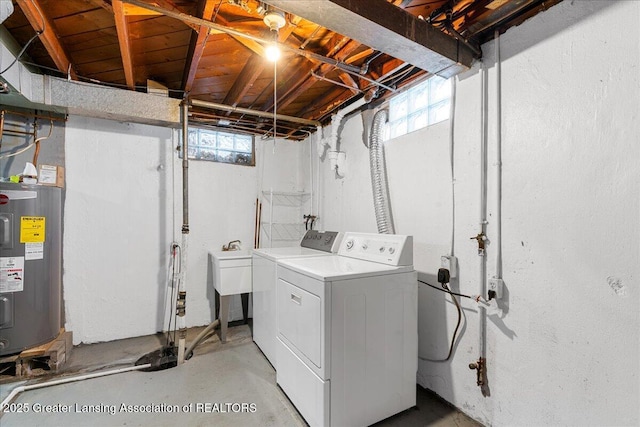 clothes washing area featuring laundry area, plenty of natural light, and washer and clothes dryer