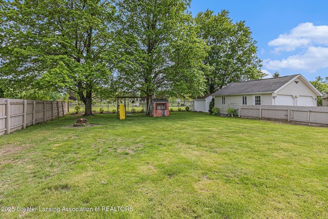 438 Union St, Grand Ledge, MI 48837 - view of yard featuring an outbuilding and an outdoor fire pit