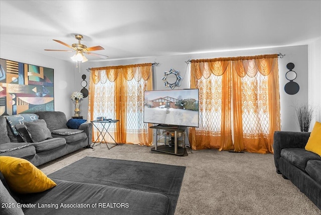 living room with a ceiling fan and carpet flooring