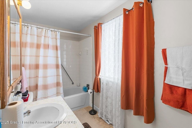 full bathroom featuring tile patterned flooring, a sink, and shower / tub combo with curtain