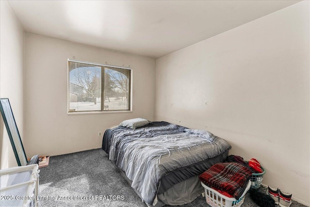 bedroom featuring dark carpet